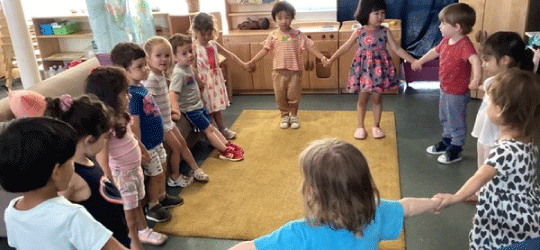 children in a circle holding hands