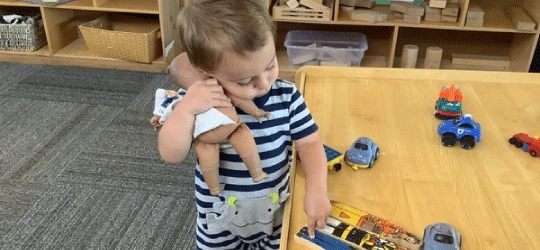 child holding a doll